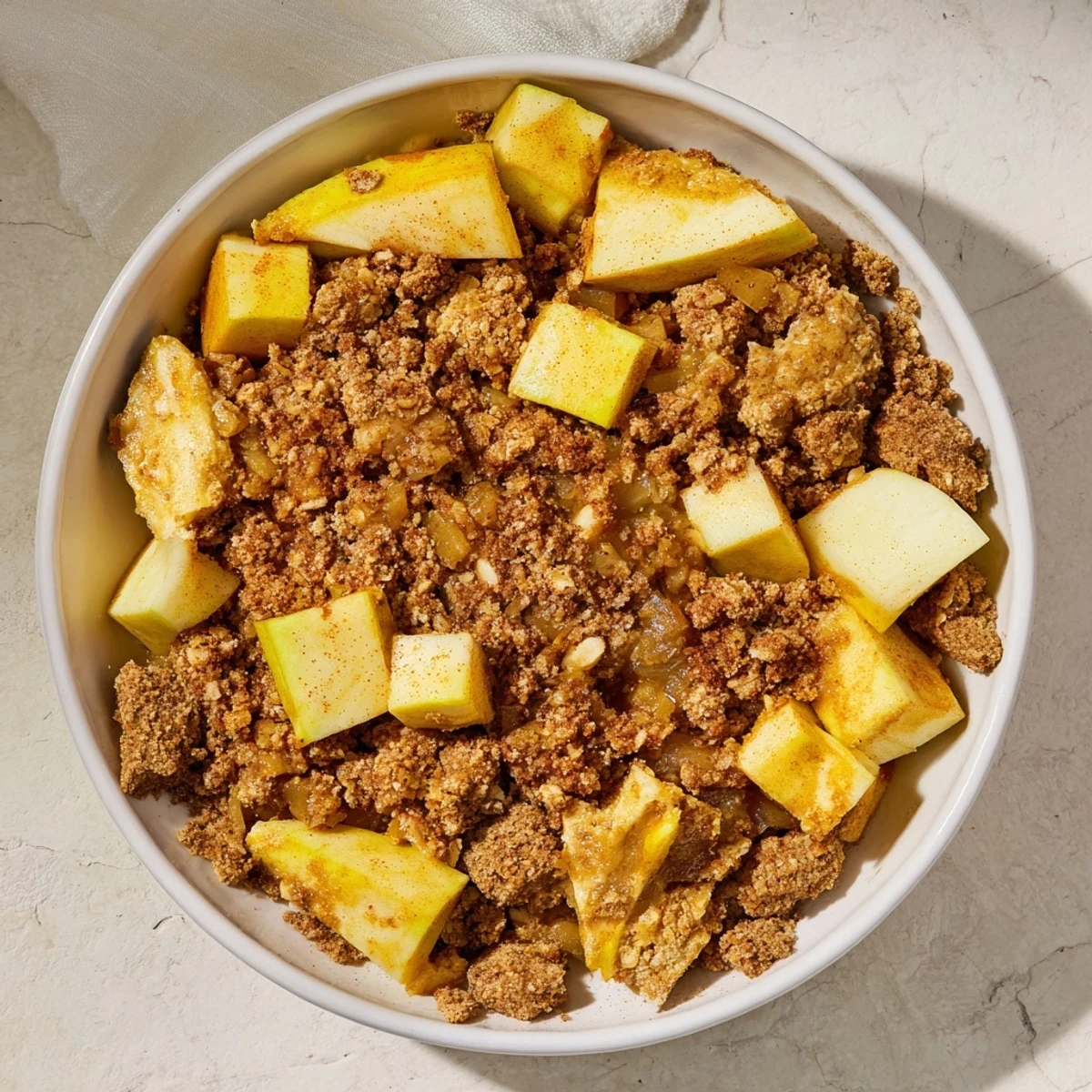 Freshly baked Warm Rustic Apple and Cinnamon Crumble, with a buttery, cinnamon-spiced topping, smells divine.