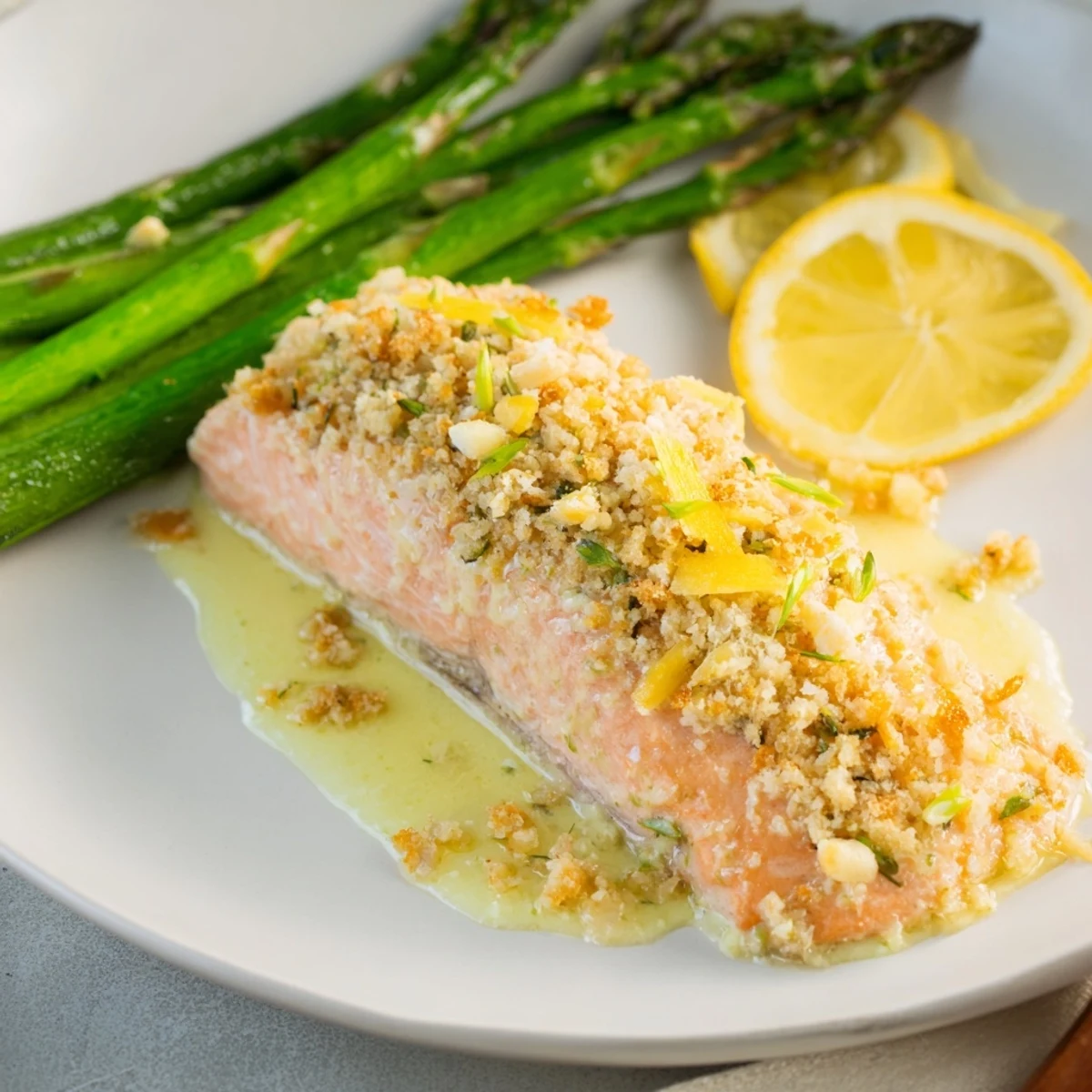 Skillet Lemon-Butter Salmon with Asparagus: Flaky salmon glistens, bathed in a bright lemon-butter sauce next to tender asparagus.