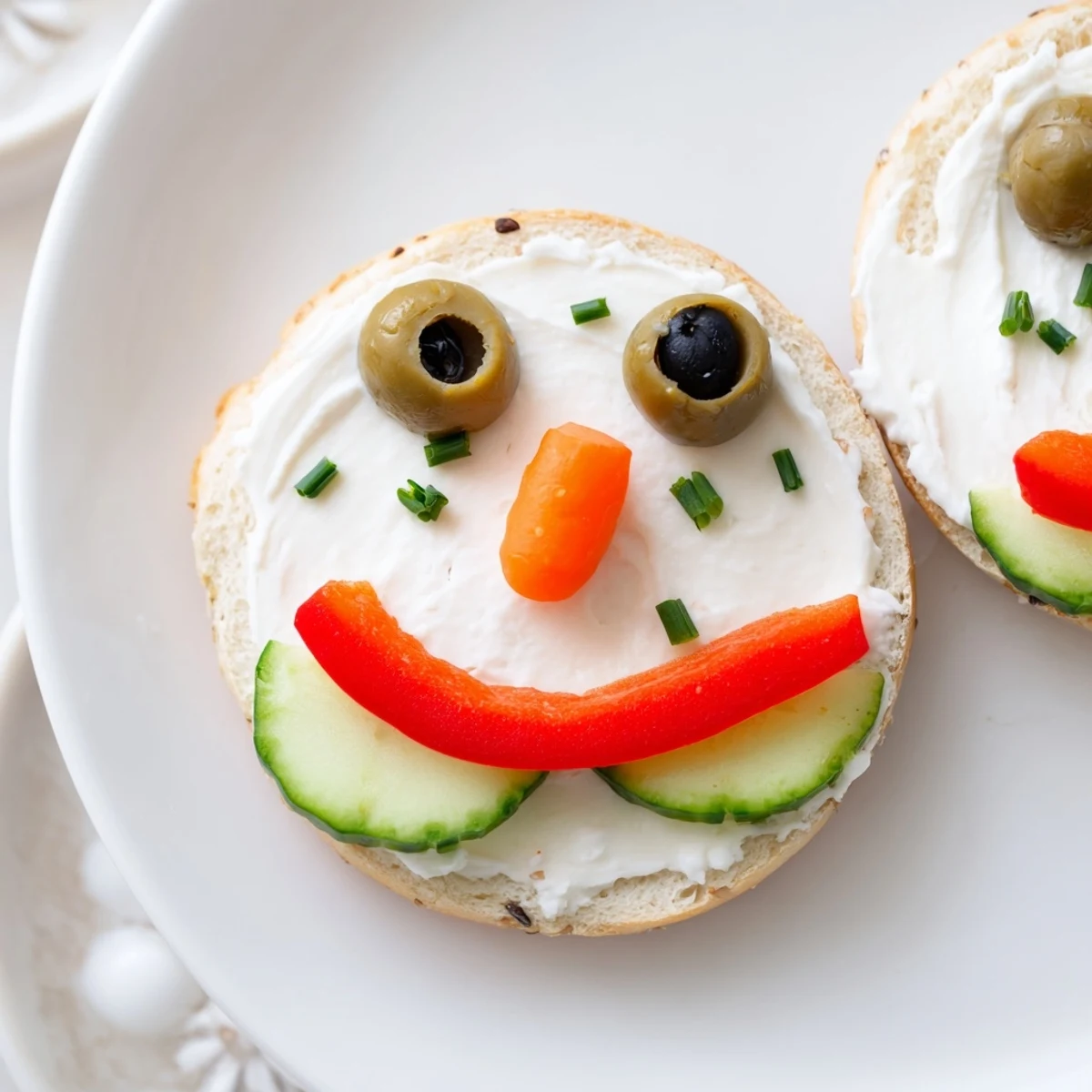 Snowman Mini Bagel Sandwiches featuring happy faces, ready for a fun, festive holiday lunch.