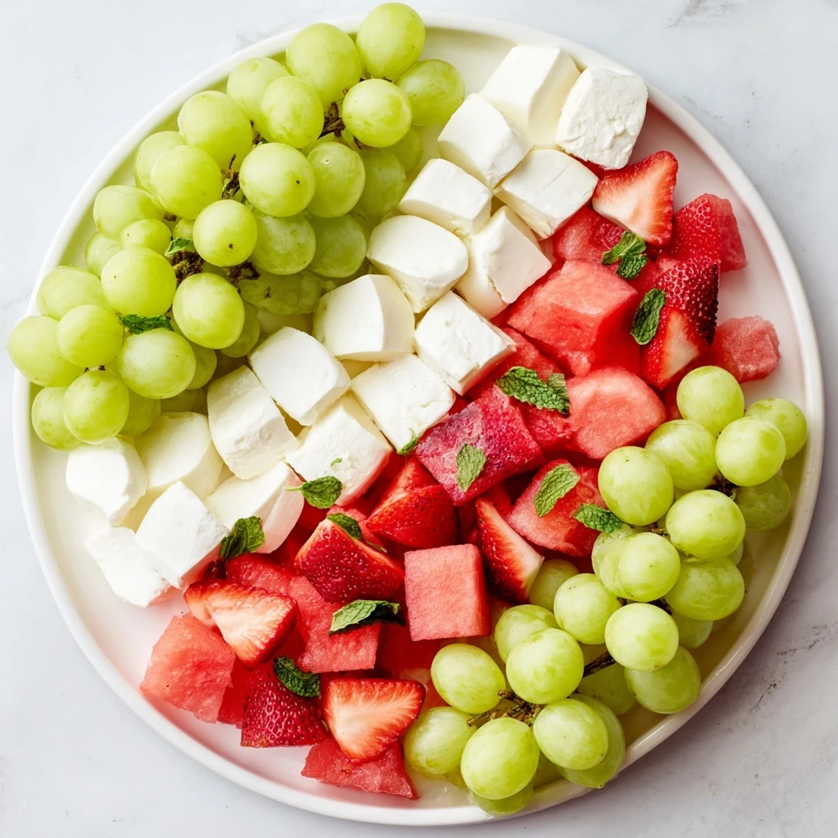 Summer watermelon slice appetizer: a refreshing platter with vibrant watermelon cubes and creamy cheese, perfect for summer.