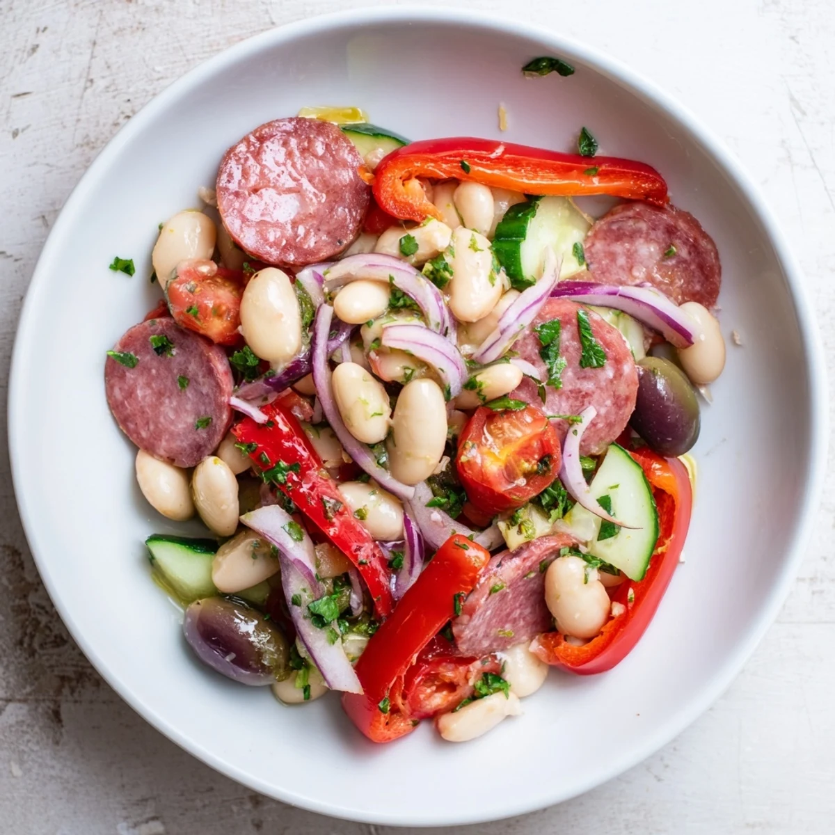 Vibrant Italian Antipasto Bean Salad with salami and provolone cheese, a perfect appetizer.