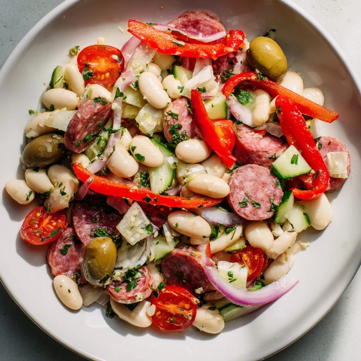 Fresh Italian Antipasto Bean Salad features hearty cannellini beans, Italian dressing, and olives.