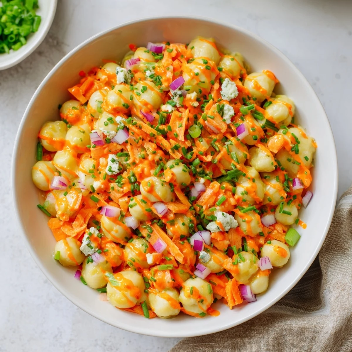 Buffalo chicken bean salad with vibrant vegetables and creamy blue cheese crumbles.
