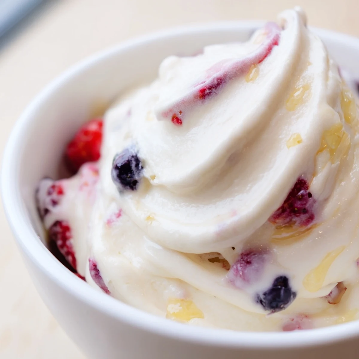Scoops of homemade cottage cheese ice cream, showcasing a vibrant, frozen dessert bursting with berry flavor.