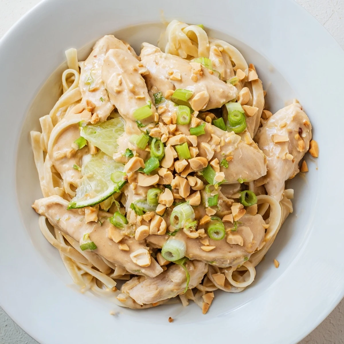 Enjoy a delicious plate of Thai Peanut Chicken Pasta, with aromatic peanut sauce and a burst of lime.