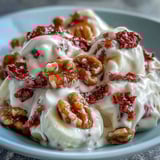 A close-up of frozen Strawberry & Banana Yogurt Clusters with marbled yogurt and honey.