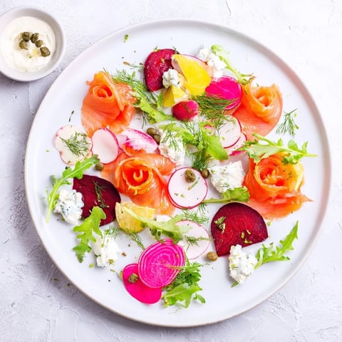 Festive Winter Harvest Smoked Salmon Board with colorful vegetables, perfect for a holiday appetizer.