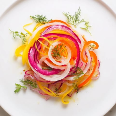 Vibrant The Spinning Top salad with shaved vegetables and herbs, ready to be drizzled with dressing.