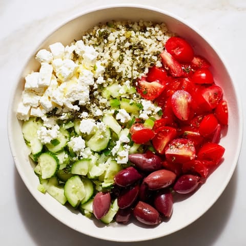 Tangy Greek Lemon-Orzo Bean Salad featuring tender orzo, chickpeas, and a zesty lemon dressing, ready to eat.