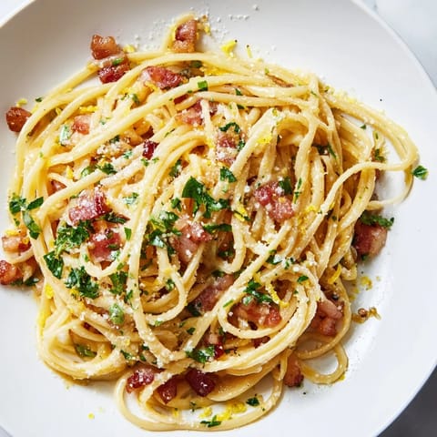 Golden-brown bacon bits and linguine tossed in a silky, starchy pasta water sauce, no cream needed.