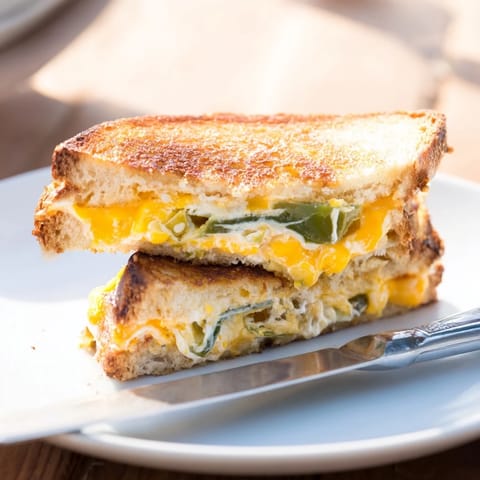 Buttery, crispy sourdough slices reveal a spicy, creamy filling in this irresistible Jalapeño Popper Grilled Cheese, perfect for a cozy lunch.