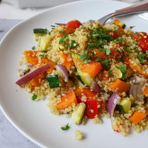 A hearty bowl of Quinoa Vegetable Pilaf features colorful roasted vegetables and fresh parsley, offering a nutritious and gluten-free vegetarian main dish for any weeknight.