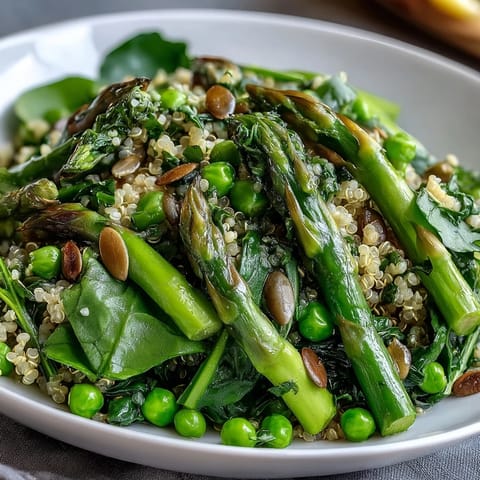 A wholesome Spring Green Bowl topped with toasted pumpkin seeds and zesty lemon dressing for a fresh meal.