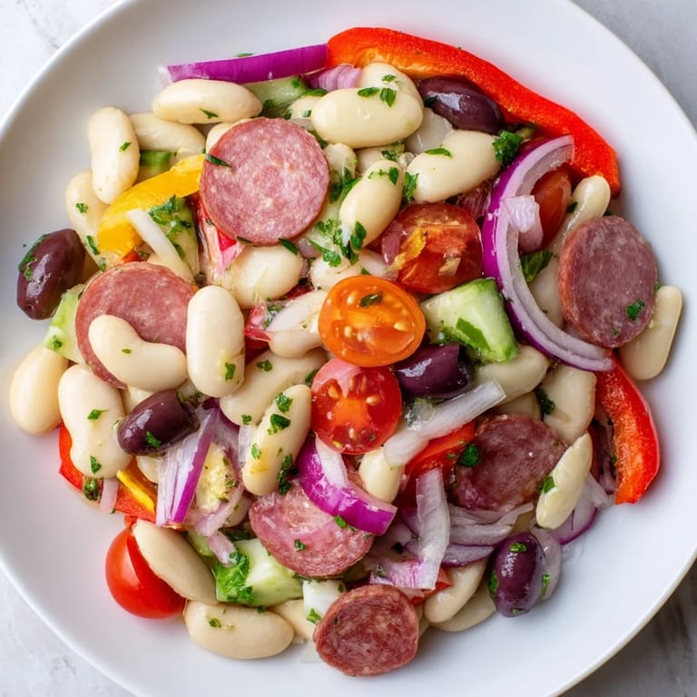 Prepare a delicious Italian Antipasto Bean Salad: a chilled, gluten-free delight, ready in minutes.