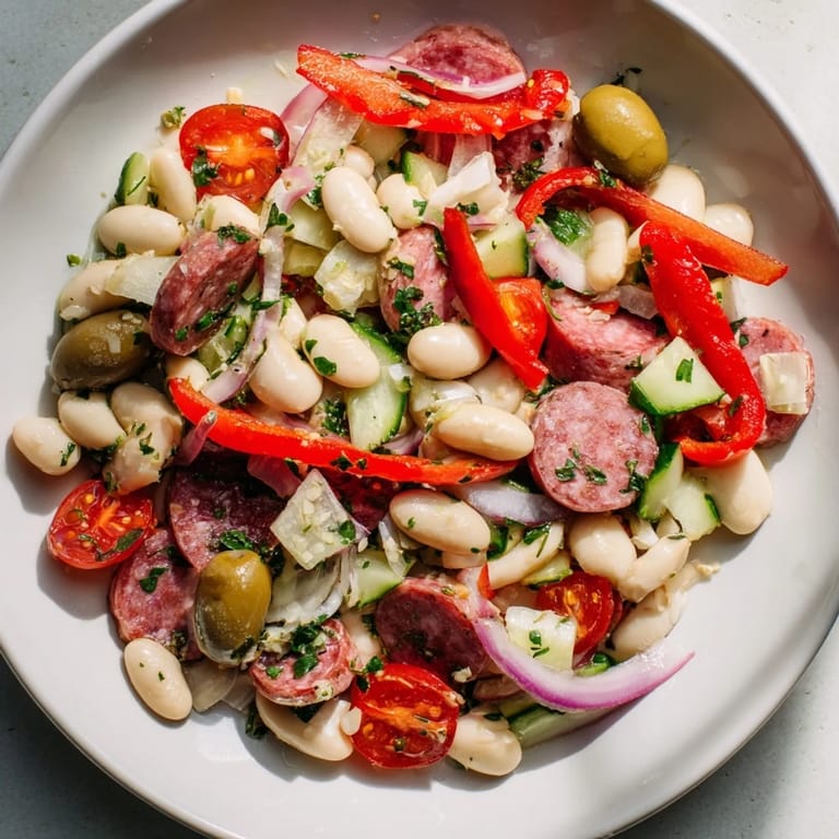 Fresh Italian Antipasto Bean Salad features hearty cannellini beans, Italian dressing, and olives.