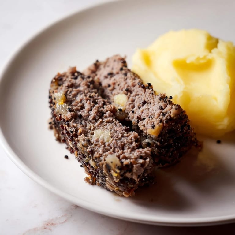 A close-up of a steaming plate of authentic Scottish haggis, rich in flavor with its traditional seasonings.