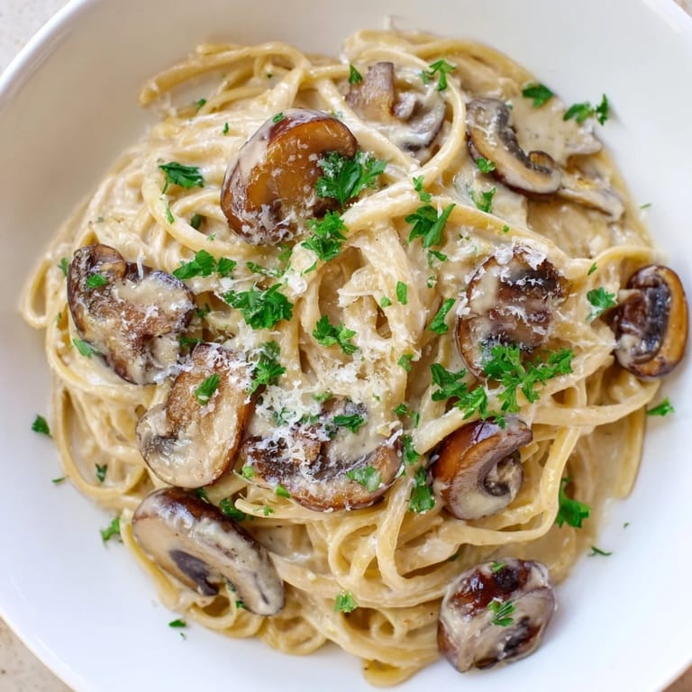 Enjoy Creamy Mushroom Linguine, a vegetarian Italian main dish with earthy mushrooms and parmesan.