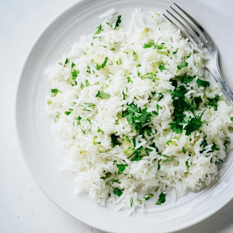 Fluffy, aromatic cilantro lime rice garnished with fresh cilantro, perfect as a vegan side for Mexican-inspired meals.