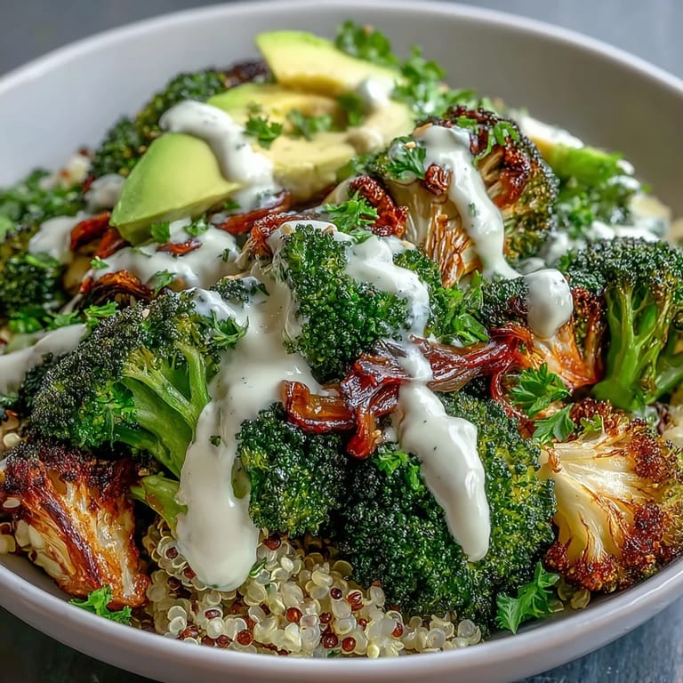 Roasted Broccoli Bowl with golden, crunchy florets, creamy tahini drizzle, and lemon wedges, served over wholesome grains for a healthy vegan dinner.