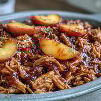 Juicy pulled pork with sweet honey peach BBQ sauce, slow-cooked to perfection for summer gatherings.
