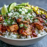 Vibrant Salsa Chicken Bowls with shredded chicken, rice, black beans, and fresh toppings in a colorful, satisfying meal.  